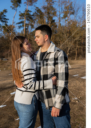 Young Couple Embracing Under Blanket During Winter Road Trip Young Couple Embracing Under Blanket During Winter Road Trip 143790610