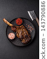 Grilled beef Tomahawk steak seasoned with salt and spices. Tomahawk steak 143790886