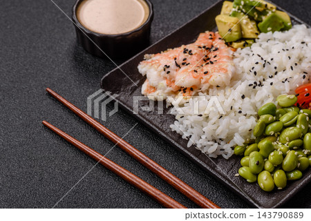 An Asian style bowl with shrimp, edamame, tomatoes, and wakame. A shrimp and vegetable bowl 143790889