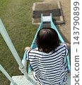 A vast landscape unfolds on a small back. 143790899