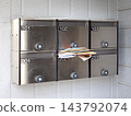 A communal mailbox in an apartment building overflowing with mail - Tokyo 143792074