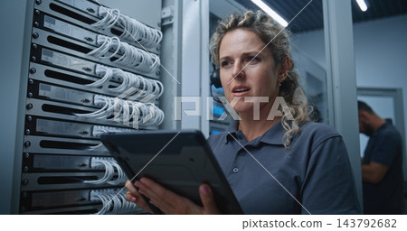Female Server Room Technician Receiving Technical Guidance While Troubleshooting Server Connections Female Server Room Technician Receiving Technical Guidance While Troubleshooting Server Connections 143792682