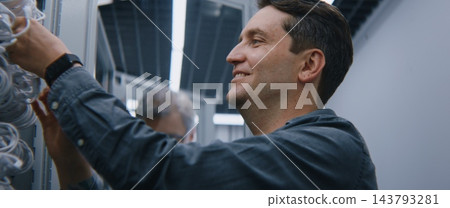 Specialist Advising System Administrator While Reviewing Network Cabling in Modern Server Facility Specialist Advising System Administrator While Reviewing Network Cabling in Modern Server Facility 143793281