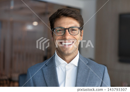 Headshot portrait of smiling Latino businessman in formal suit Headshot portrait of smiling Latino businessman in formal suit 143793307
