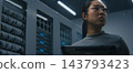 IT Engineer Examining High Density Network Ports, Cable Connections While Reviewing Data on Tablet 143793423