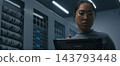 IT Engineer Examining High Density Network Ports, Cable Connections While Reviewing Data on Tablet 143793448