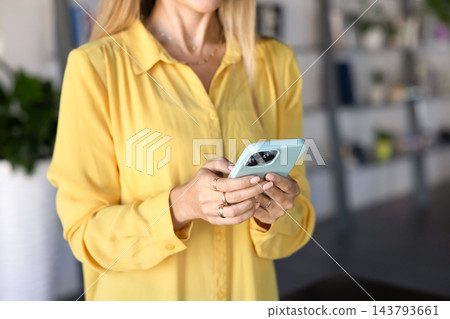 Woman using smartphone in modern office, close up 143793661