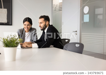 Colleagues looking at laptop screen, discussing business information Colleagues looking at laptop screen, discussing business information 143793671