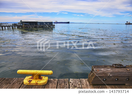 Dockside Waterfront View with Yellow Mooring Bollard and Pier in Port Angeles Dockside Waterfront View with Yellow Mooring Bollard and Pier in Port Angeles 143793714