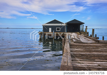 Rustic Wooden Dock and Wharf Buildings on Tranquil Waterfront in Port Angeles Washington Rustic Wooden Dock and Wharf Buildings on Tranquil Waterfront in Port Angeles Washington 143793716