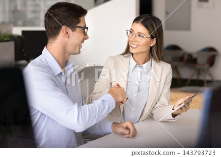 Happy young Latin male and female business colleagues getting agreement Happy young Latin male and female business colleagues getting agreement 143793723