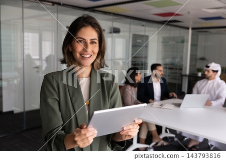 Latina businesswoman using digital tablet standing in conference room, portrait 143793816
