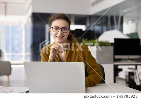 Happy woman working remotely from modern office Happy woman working remotely from modern office 143793928