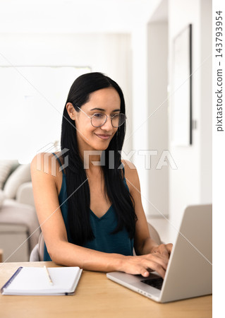 Adult woman studying on laptop at home 143793954