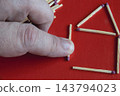 Finger Pushing Matchstick Near Matchstick House On Red Background, Concept Of Fire Risk And Prevention 143794023