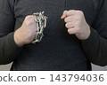 Man Holding Metal Chain Around Fist, Symbolizing Restraint, Struggle And Desire For Freedom 143794036
