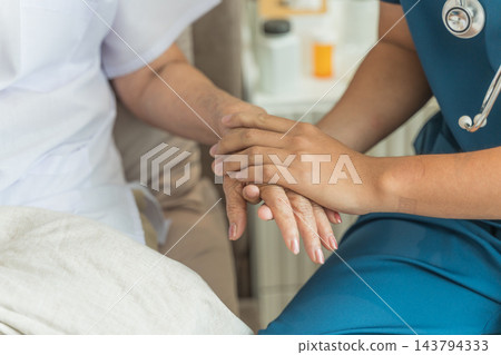 Healthcare worker comforting senior patient in home care setting. Healthcare worker comforting senior patient in home care setting. 143794333