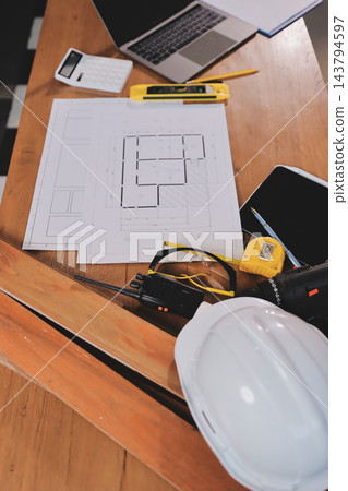 Asian architect and engineer team checking architectural house model using measuring tape on the table at office studio. Asian architect and engineer team checking architectural house model using measuring tape on the table at office studio. 143794597
