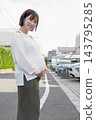 A cute woman who is 8 months pregnant 143795285