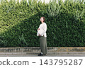 A cute woman who is 8 months pregnant 143795287
