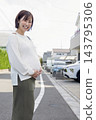 A cute woman who is 8 months pregnant 143795306