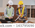 Asian architect and engineer team checking architectural house model using measuring tape on the table at office studio. 143795690