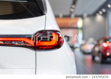 rear view of new modern white car led tail lights in showroom rear view of new modern white car led tail lights in showroom 143795876
