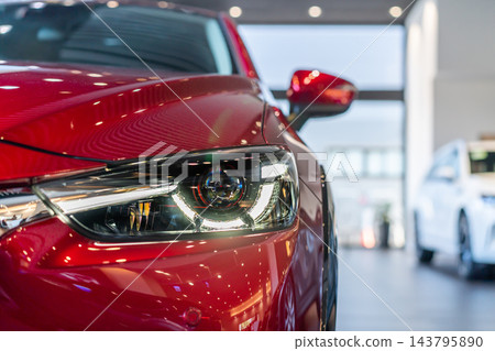 front view of new modern white car led headlight in showroom 143795890
