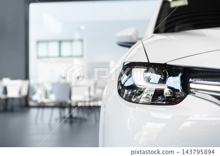 front view of new modern white car led headlight in showroom front view of new modern white car led headlight in showroom 143795894