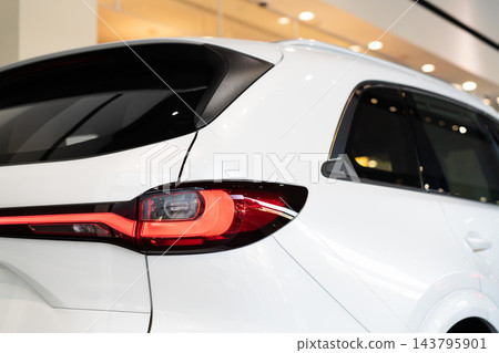 rear view of new modern white car led tail lights in showroom rear view of new modern white car led tail lights in showroom 143795901