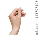Female hand holding a thin object between thumb and forefinger on transparent 143797108
