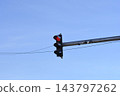 Traffic light showing red signal against a clear blue sky 143797262