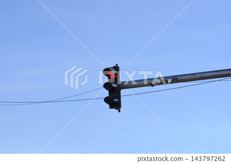 Traffic light showing red signal against a clear blue sky 143797262