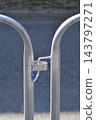 Metal crowd control barriers connected together on a street 143797271