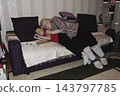 grandmother is reading colorful book grandson, has leaned in closer to listen. grandmother wearing glasses, boy, dressed red T-shirt, is intently examining the book and listening to the story. 143797785