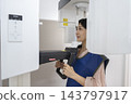 A female patient receiving an X-ray at a dental clinic. 143797917
