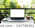 Laptop with white screen and coffee glass cup and notebook 143798362
