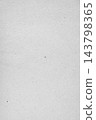 Vertical kraft grey paper sheet texture with visible fibrous specks 143798365