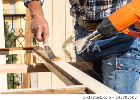 Carpenter at work, restoring an old wooden window. Carpentry. Carpenter at work, restoring an old wooden window. Carpentry. 143798508