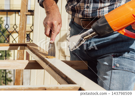 Carpenter at work, restoring an old wooden window. Carpentry. Carpenter at work, restoring an old wooden window. Carpentry. 143798509