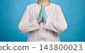 Doctor in a white coat and blue medical gloves holding hands in a praying or pleading gesture, medic hoping for recovery 143800023