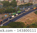 High angle view of busy multi-lane toll road and bridge with trucks and cars driving over Kali Surabaya river 143800111