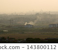 Aerial view of severe air pollution, dust smog, and industrial smoke haze covering suburban landscape and skyline 143800112