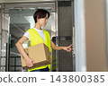 Female delivery driver 143800385