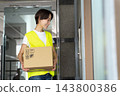 Female delivery driver 143800386