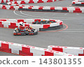 Go kart racer driving on outdoor karting track on a sunny day 143801355
