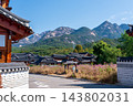 Traditional Korean Hanok Houses and Tiled Roofs against Bukhansan Mountain in Eunpyeong Hanok Village, Seoul 143802031