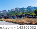 Traditional Korean Hanok Houses and Tiled Roofs against Bukhansan Mountain in Eunpyeong Hanok Village, Seoul 143802032