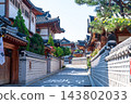 Traditional Korean Hanok Houses and Tiled Roofs against Bukhansan Mountain in Eunpyeong Hanok Village, Seoul 143802033