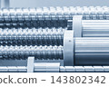 Close-up of a ball screw and bushing set in a CNC milling machine structure in a blue tone scene 143802342